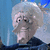 Animated sequence of a character with white hair and mustache against blue background, showing subtle facial expression changes.