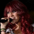 A pixelated image of a person with long red hair holding a microphone against a dark background.