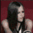 Animated contact sheet of a woman in black sleeveless top and striped arm warmers against maroon background with text "avril lavigne" on right panel.