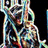 Pixelated static image of a stylized figure with multicolored segments against black background, featuring abstract shapes and blended hues.
