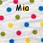Pixelated static image with scattered colored circles and a central black-and-yellow text element on light background.