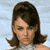 Static pixelated image of a person with shoulder-length dark brown hair against a light blue background, rendered in low-resolution 256x256 pixels.