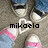 Pixelated static image of a character with dark hair, light skin, and pink-and-blue clothing, overlaid with the text 'mikaelo' and a white heart outline.