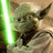 Pixelated image of a green-skinned character with large ears holding a green lightsaber, set against a brown background.