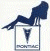 A pixelated figure in dark blue clothing reclines on a gray structure with a white base and triangular emblem.