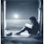 Pixelated static image shows a dark silhouette of a person sitting on a bench by water under a bright light source, framed by vertical lines.