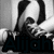 A grayscale anime-style character with dark hair and a white shirt, holding a hand to their face, with the name 'Alijah' displayed below in dark text.
