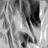 Black-and-white animated icon showing a person with long wavy hair and a smiling expression, with visible motion in hair and mouth.