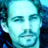 Pixelated static image of a person's face with blue and cyan color palette, low-resolution rendering on dark background.