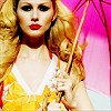 A static image of a woman with long blonde hair wearing a yellow dress with white trim, holding a pink umbrella against a pink background.