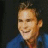 A split-frame contact sheet showing a pixelated image of Sean William Scott on the left and green text reading "OriginalIcons.com" on the right against a dark background.