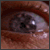 A four- shows an eye transitioning from a dark, cloudy state to clear and bright, with text below reading "ALONE In The DARK" and "IN THEATERS JANUARY 28"