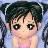 Pixelated character with dark hair in pigtails, large black eyes, and pink cheeks wearing a pink sleeveless top against a light blue background.