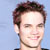 Static 50x50 pixel buddy icon showing a close-up of a person's face with brown hair against a light blue background, rendered in low-resolution pixel art style.
