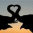 A pixelated image shows a black silhouette of two figures forming a heart shape with their arms against a gradient sky, next to green text reading 'elephant love notin stronger'.