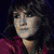 Six distinct celebrity portraits arranged in a with a central yellow displaying purple text