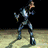 Pixelated character in blue and silver armor running on a dark background with light ground, transitioning to crouching pose against gray backdrop.