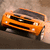 Pixelated orange car with black grille and headlights, angled view on brown background.