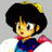 Pixelated anime-style character with black afro hair and yellow highlights, wearing blue and red clothing, positioned next to black background with white text.