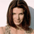 Pixelated image of a person with shoulder-length brown hair, closed eyes, and a neutral expression against a light background.