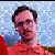 A static image with a small photo of a person in an orange shirt on the top-left, surrounded by red text fragments and distorted visual elements.