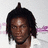 Pixelated image of a person with dark skin and long dreadlocks wearing a white shirt, alongside red text reading CHAUN THOMAS on a white background.