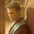 Pixelated static image of a person with short light brown hair wearing a dark jacket over a white shirt, positioned against a warm-toned background.