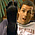 Pixelated image of two figures standing side-by-side, one in dark clothing with a light-colored sleeve visible, the other in a light shirt with a patterned design.