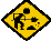 Yellow diamond-shaped warning sign with black border showing a worker digging, surrounded by small rocks and dust particles.