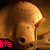 A pixelated image of a mushroom with a glowing cap and stem, set against a brown background with the word 'life' in pink text at the bottom left.