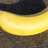 A pixelated image split vertically with a yellow curved shape on the left and a solid yellow background on the right containing black pixelated text.