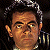 A pixelated buddy icon featuring a character with dark hair and a microphone on the left, next to green text reading "Original Icons .com" on a solid green background.
