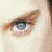 A split-screen image with a close-up of a light-skinned person's eye on the left and green text reading 'OriginalIcons.com' on a dark green background on the right.