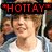 A pixelated image of a person with light brown hair wearing a white shirt and gray hoodie, with red text overlays changing across three