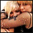 Two pairs of people embrace in a with text reading 'Spice Girls' below