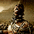 A figure with a beaded necklace and dark hair appears in showing head movement and mouth opening, with red text below