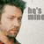 A pixelated image of a man with dark hair and a beard, wearing a red shirt, with text reading 'he's mine' in the background.