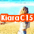 A beach scene with a woman in white clothing and blue jeans standing on sand, overlaid by orange text reading "KiaraC15".