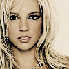 Pixelated close-up of a person with long blonde hair, dark eyeliner, and light pink lips against a plain off-white background.