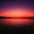 A static pixelated image of a sunset over water with horizontal bands of purple, pink, orange, and red hues reflecting on the surface.