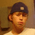 A person wearing a dark cap and light shirt appears in two ; the right displays text on black background