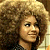 A pixelated buddy icon featuring a person with voluminous curly hair on the left and green text reading "Original Icons .com" on a dark green background to the right.
