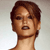 Pixelated close-up of a person with short brown hair, light skin, and a neutral expression against a gradient background.
