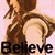 Pixelated image of a figure in brown clothing holding a circular object with the word 'Believe' below.