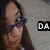 A person with long dark hair and glasses appears in a of four , each showing different text overlays