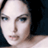 Pixelated close-up of a person's face with dark hair against a dark background, rendered in low-resolution 256x256 pixels.