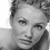 Black-and-white pixelated close-up of a person's face with visible hair and facial features, rendered in low-resolution grayscale.