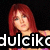 Pixelated image of a person with long red hair against a black background, with partial white text overlay.