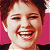 A 50x50 pixel animated buddy icon featuring a split composition with a smiling person on the left and green text on a dark background on the right, displayed as two sampled frames in a contact sheet layout.