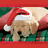 Two light brown dogs wearing red Santa hats with white trim lie on green fabric, one dog's head is turned toward the other.